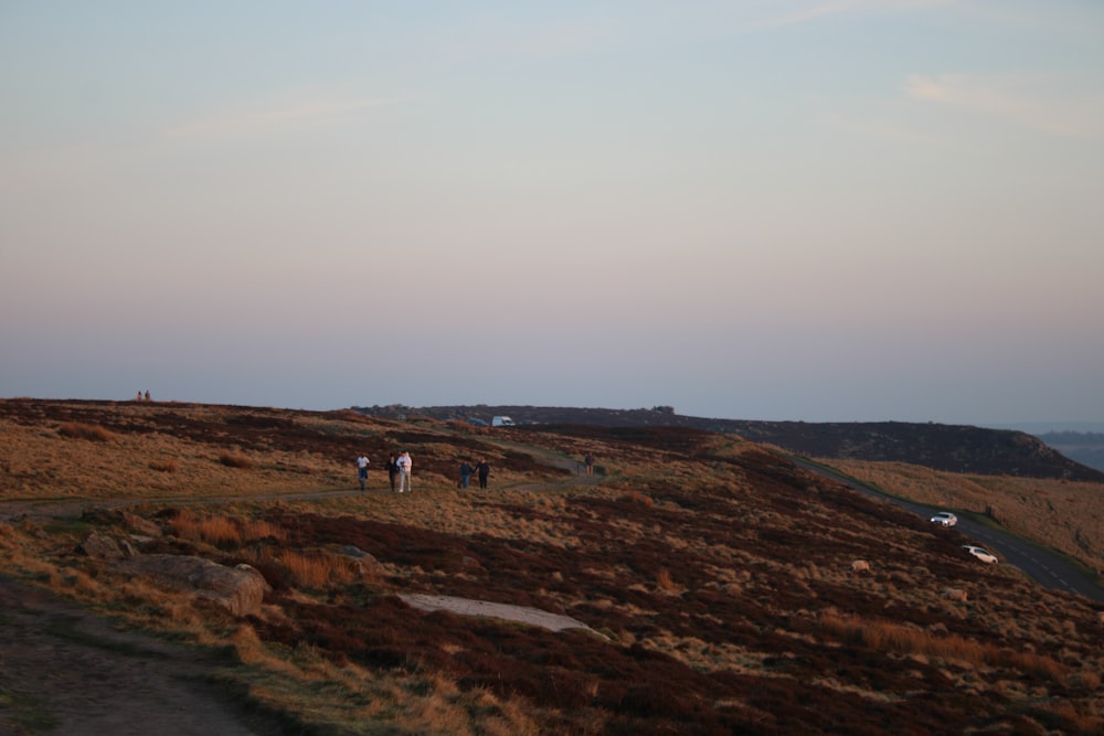 a group of people walking up a hill