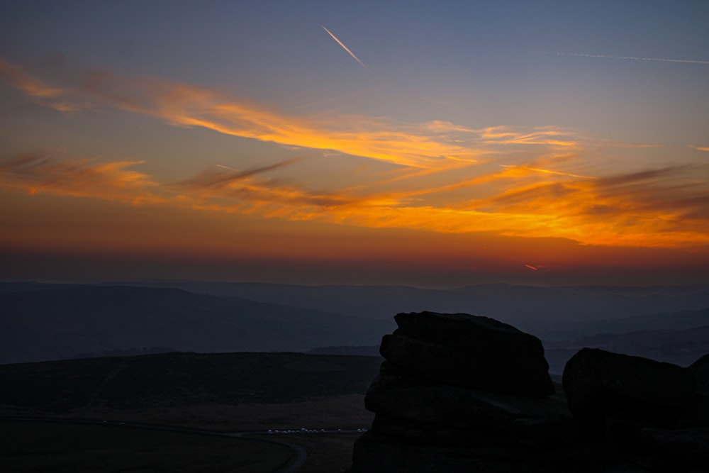 a view of a sunset over a mountain range