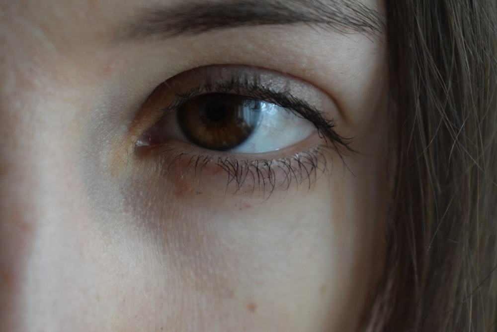 a close up of a woman's brown eye