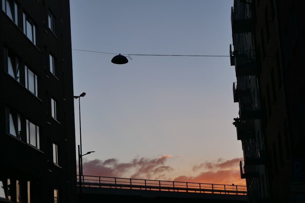 a street light hanging over a street next to tall buildings