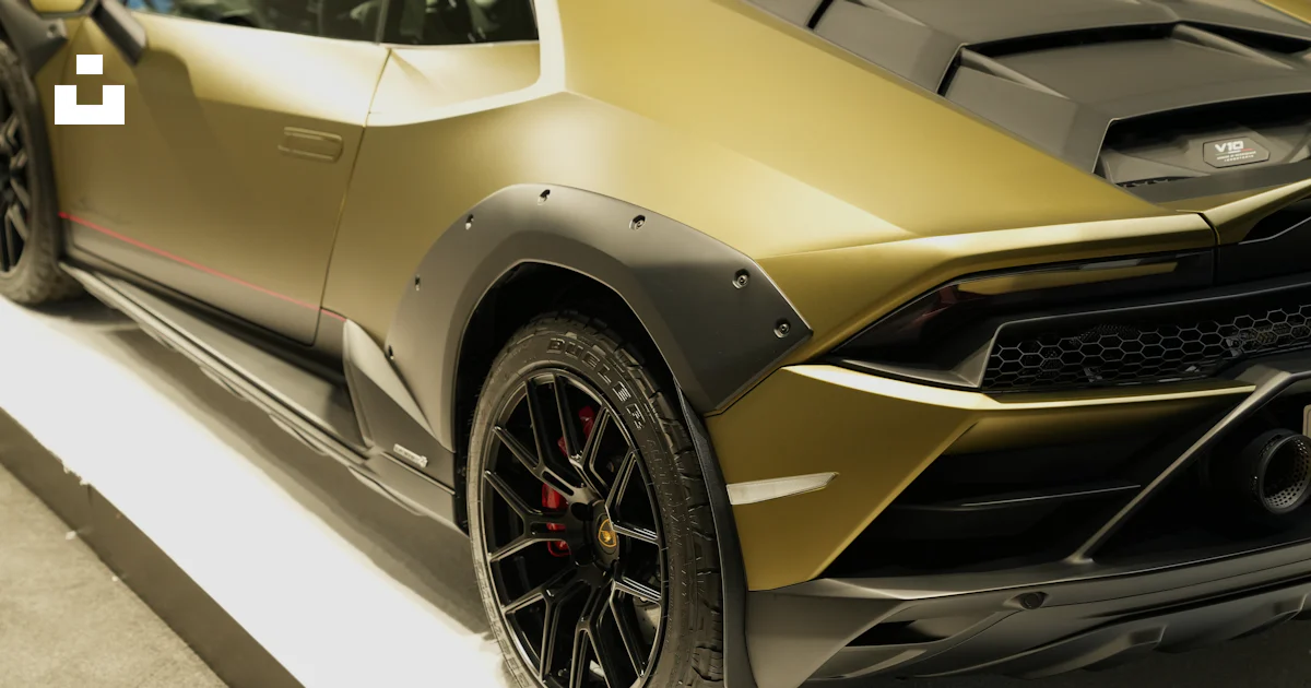 Jewish Racing Gold A gold colored sports car on display at a car show photo – Free Wheel ...