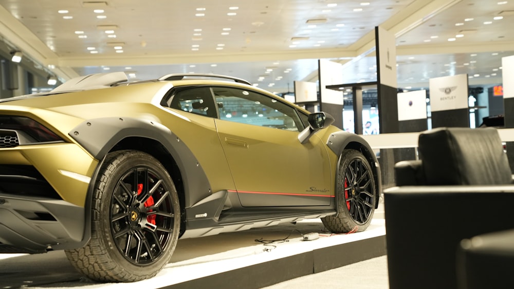 a gold sports car parked in a showroom