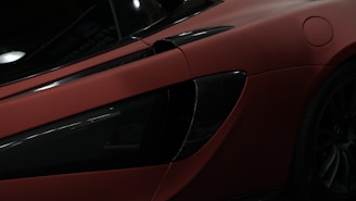 Close-up of a sleek black sports car with a flawless ceramic coating finish under natural light.