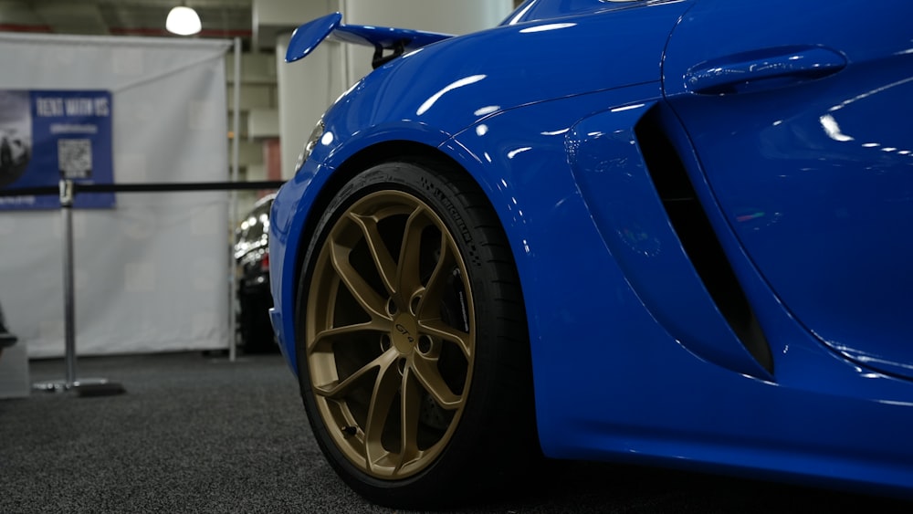 a blue sports car parked in a showroom