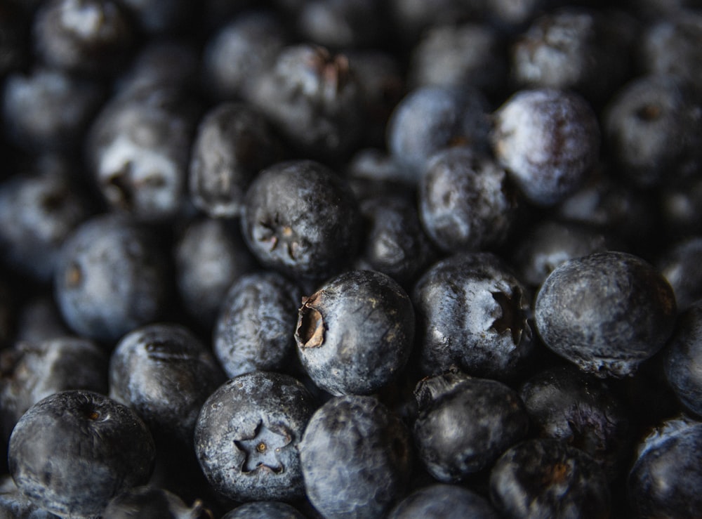 a pile of blueberries sitting on top of a table