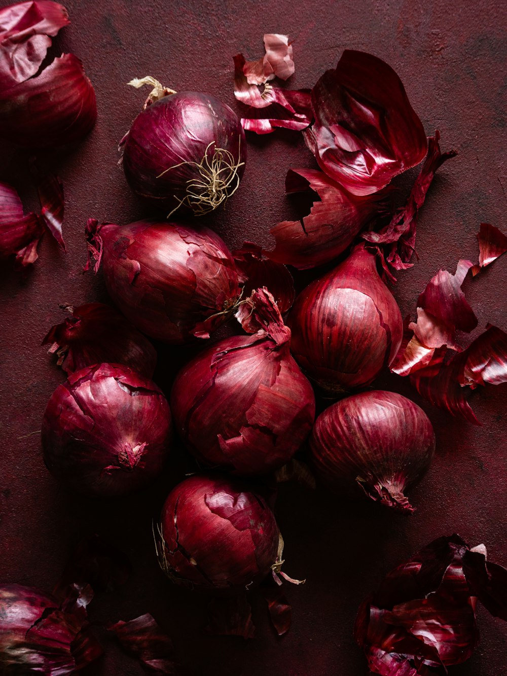 a pile of red onions sitting on top of a table