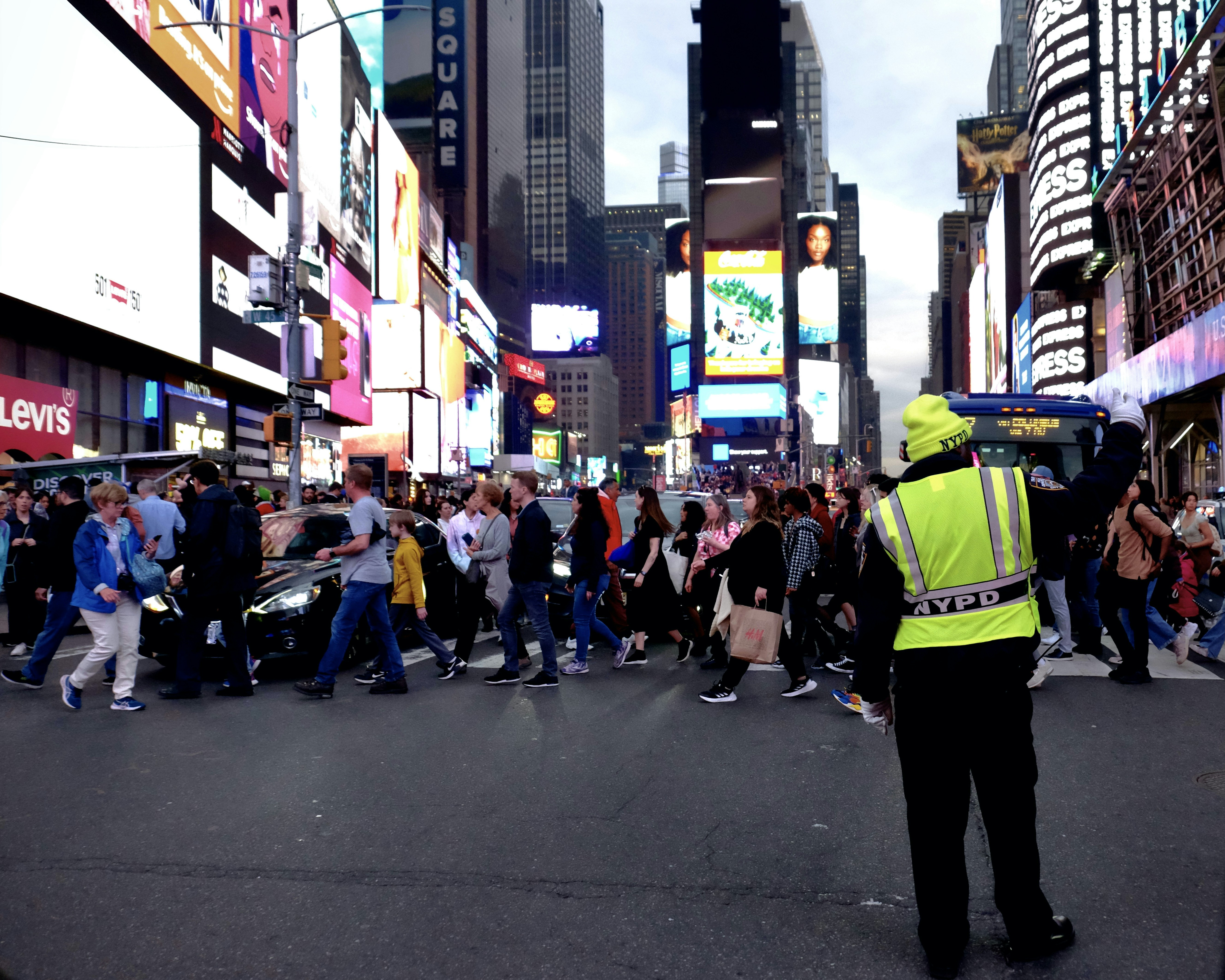 a police officer standing in the middle of a crowded street