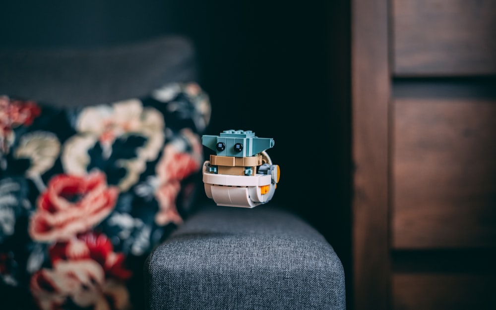 a toy boat sitting on top of a chair