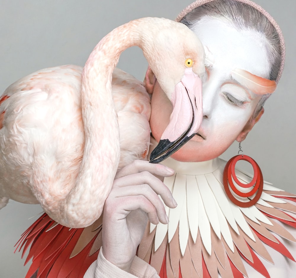 a woman with a large bird on her face