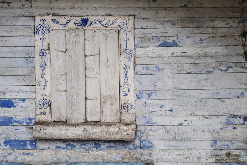 a white window with blue trim on a white wall