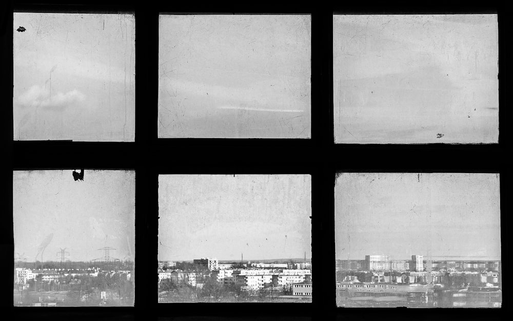 Ein Schwarz-Weiß-Foto einer Stadt, die durch ein Fenster gesehen wird