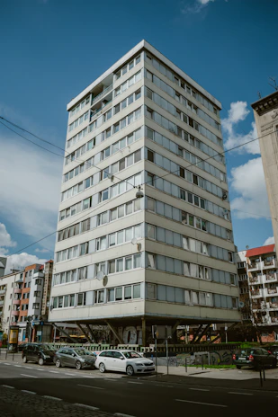 Exterior view of the low-rise residential building showcasing elegant architecture with stilt parking below.