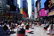 a group of people sitting on top of red chairs