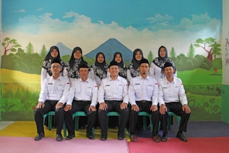 Leaders of ten groups standing together in a traditional Batak house.