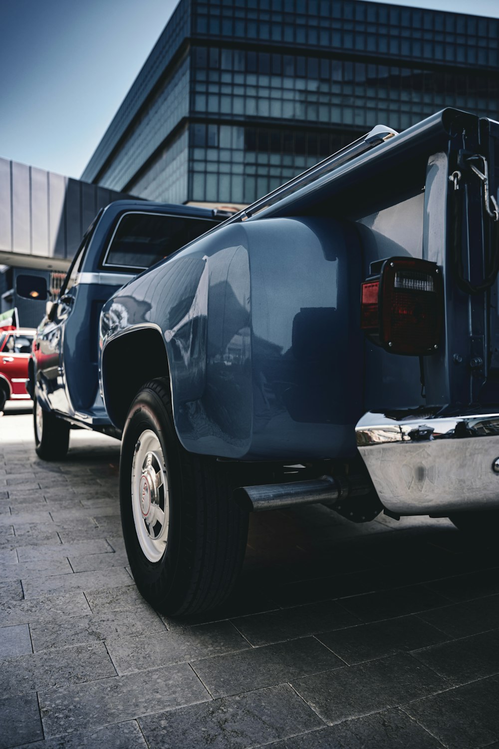 a blue pick up truck parked in front of a building