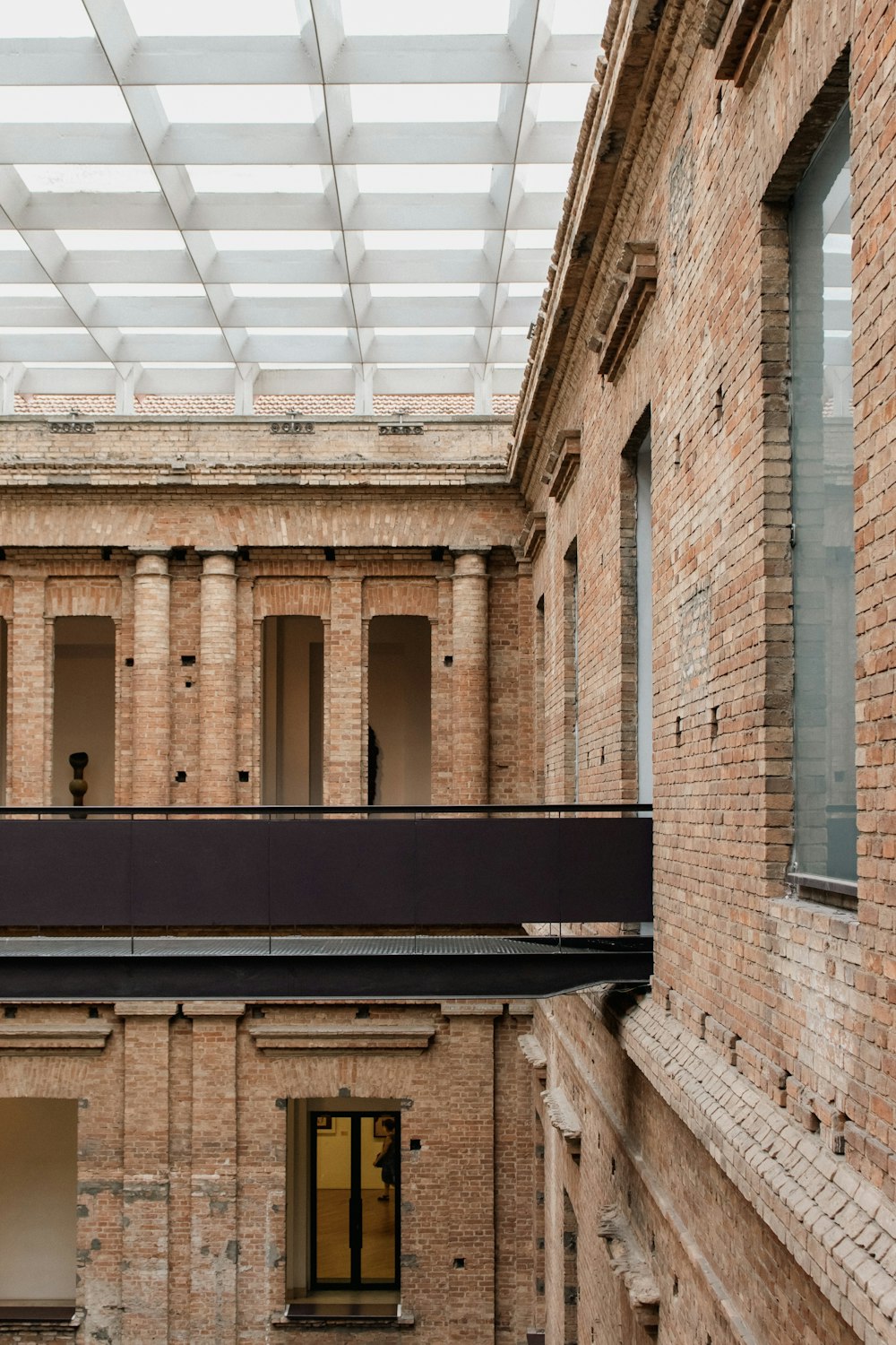 a balcony in a brick building with a skylight