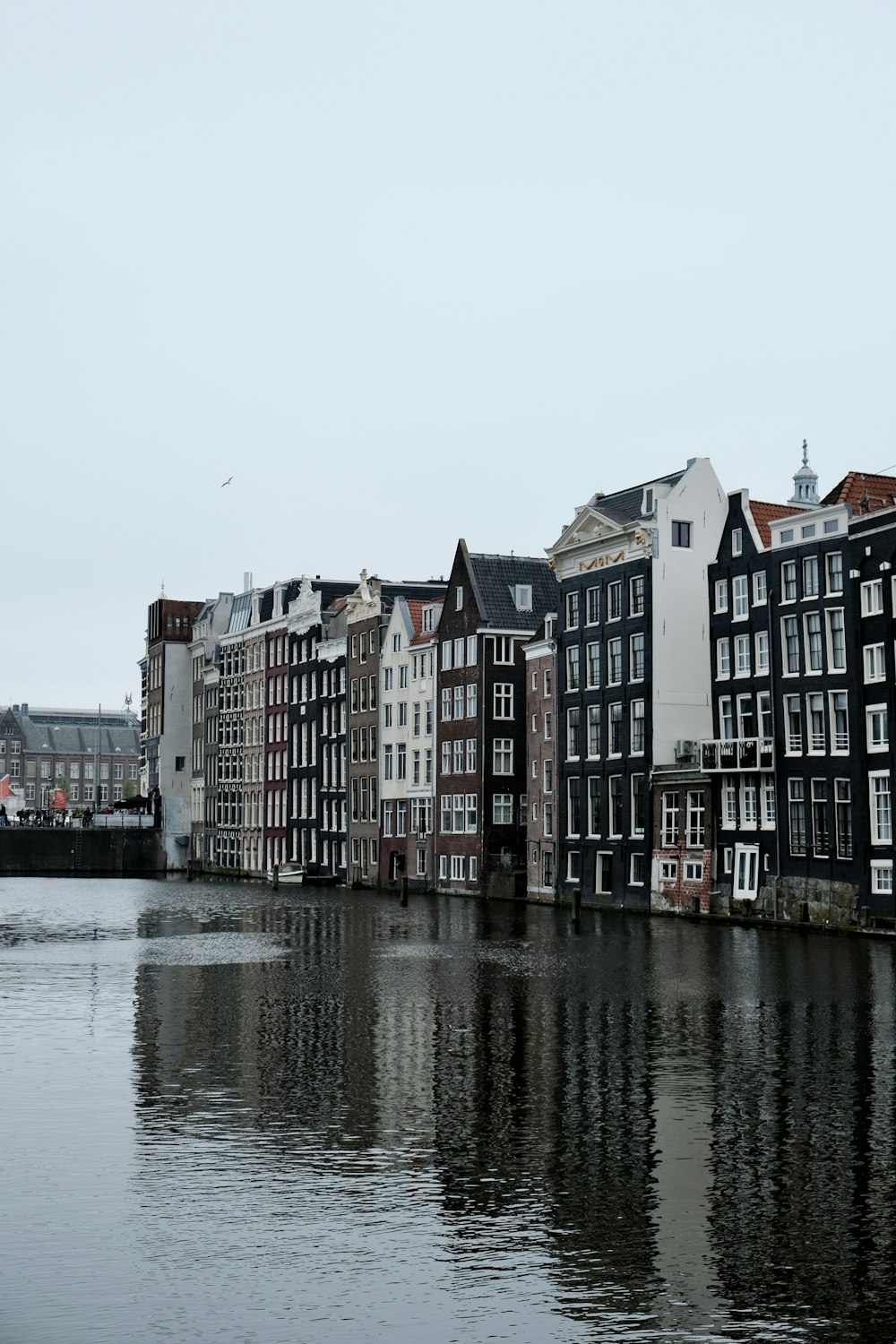 a row of buildings next to a body of water