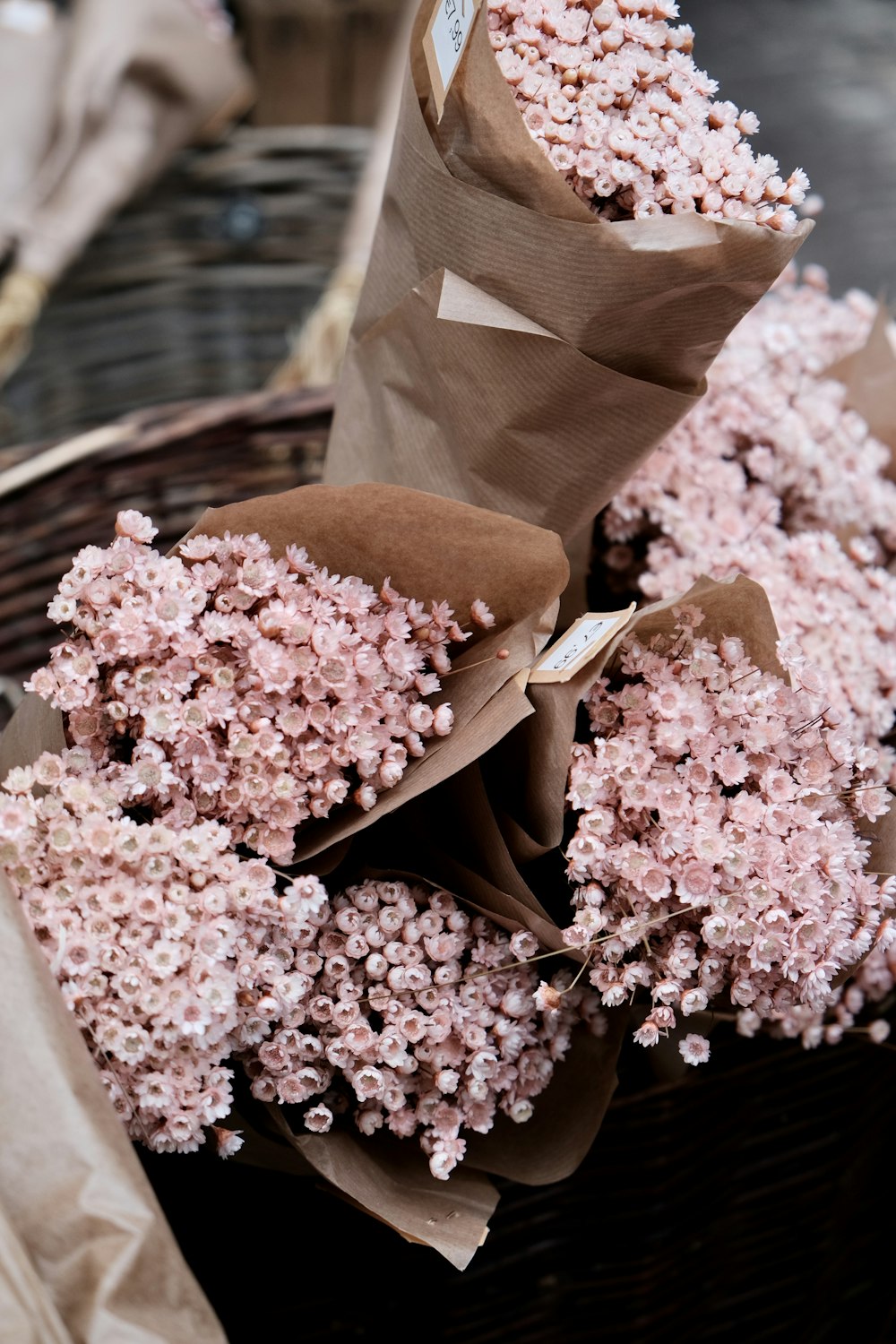 a basket filled with pink flowers on top of a table