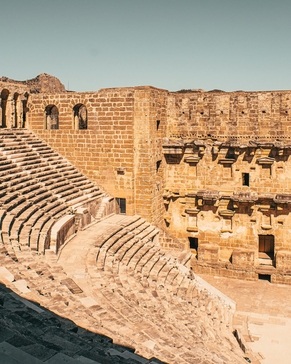 a large stone building with a bunch of seats on top of it