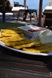 a white plate topped with cheesy fries and ketchup