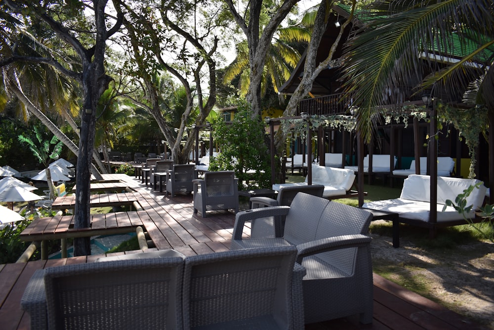 a wooden deck with chairs and umbrellas on it