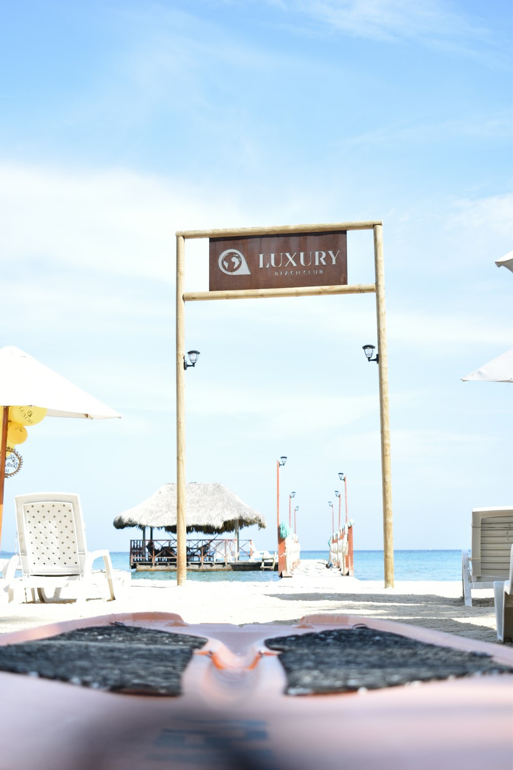 a view of a beach with a sign that says luxury