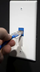 Technician installing high-speed internet router in a modern home office setting.