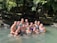 A group of women smiling together on a riverboat in the Amazon rainforest.