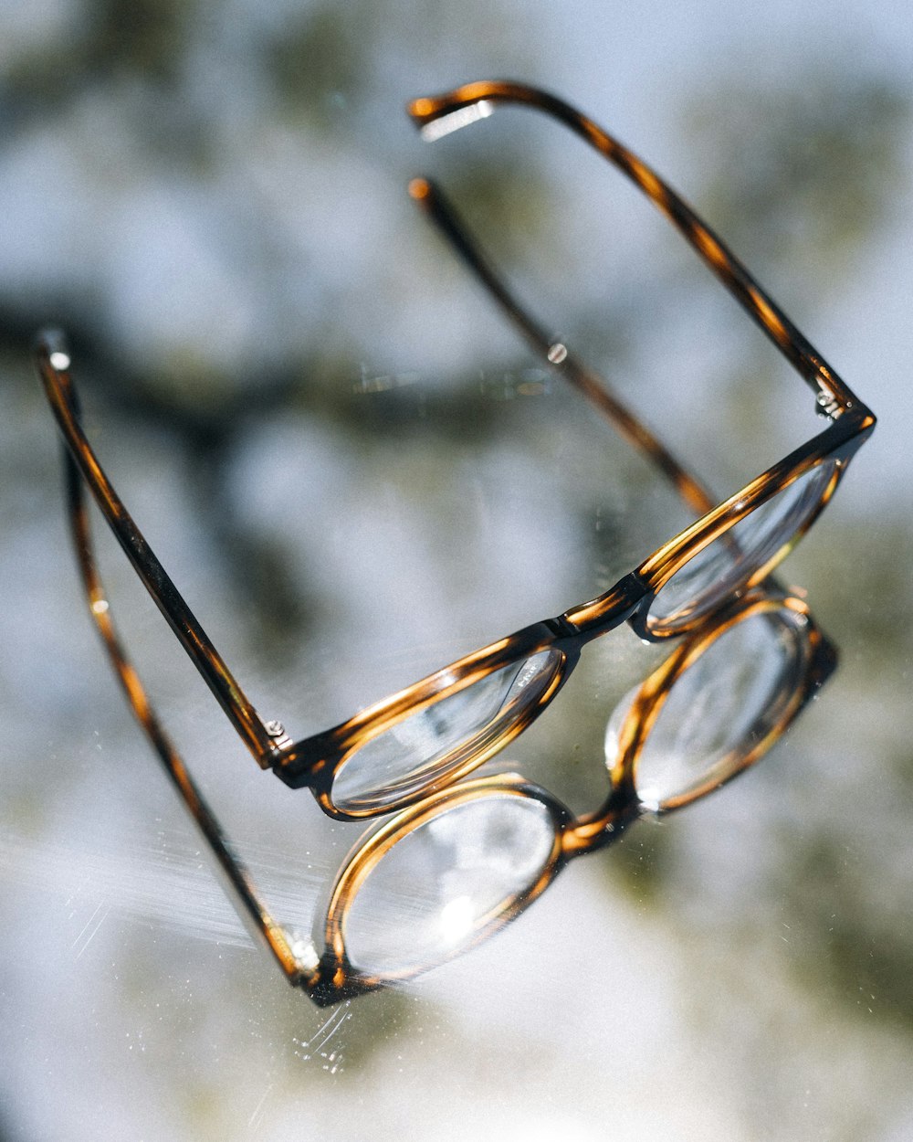 a pair of glasses sitting on top of a window sill