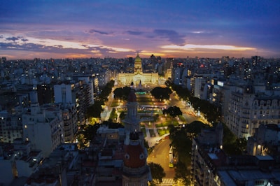 An aerial view of an iconic city skyline blending urban energy and timeless architecture at dusk.