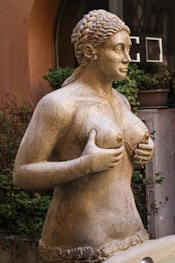 a statue of a woman in front of a building