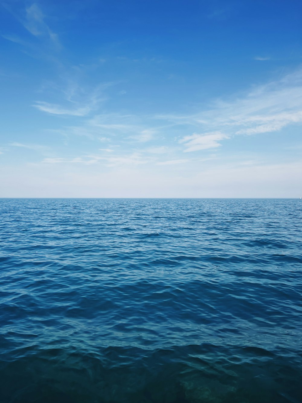 a large body of water with a sky background