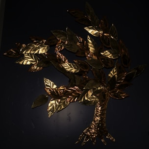 A metallic sculpture of a tree is mounted on a dark background. The tree features intricately crafted leaves with a golden sheen, giving it an elegant and artistic appearance.