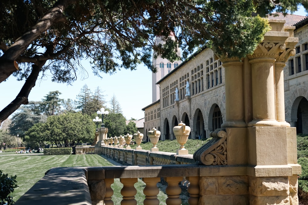 a row of statues on a stone wall in front of a building