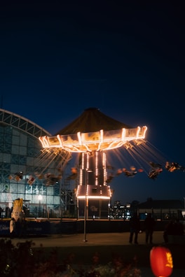 Evening scene showing the exterior of swingsim with illuminated signage against a dark sky.
