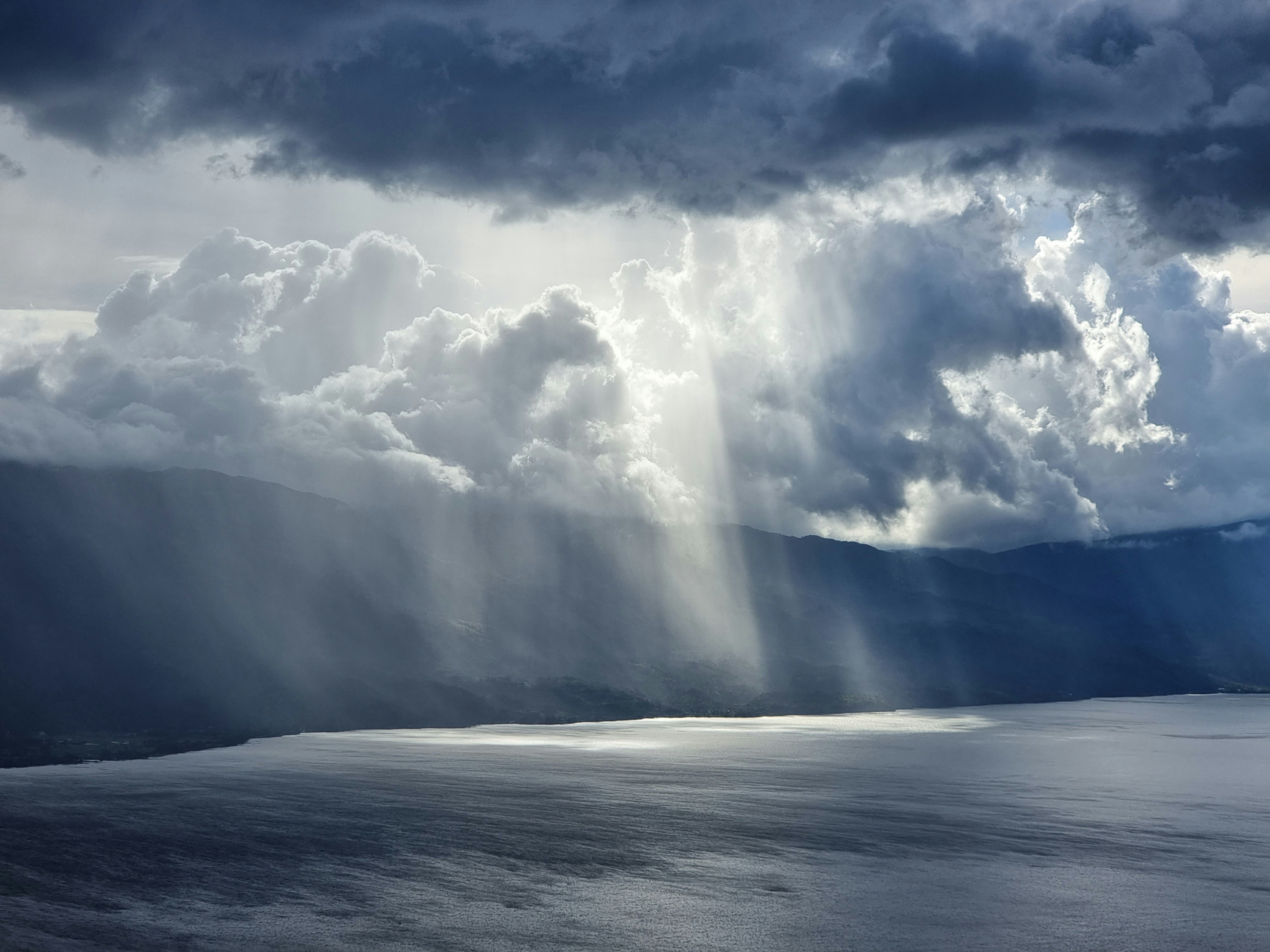 a large body of water under a cloudy sky