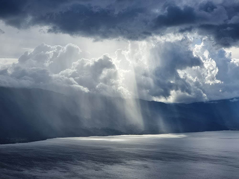 a large body of water under a cloudy sky