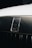 A close-up of a Rolls-Royce car emblem set against a shiny, metallic background. The emblem features the iconic double 'R' logo, indicative of luxury and elegance. The surface appears well-polished, enhancing the premium feel of the image.