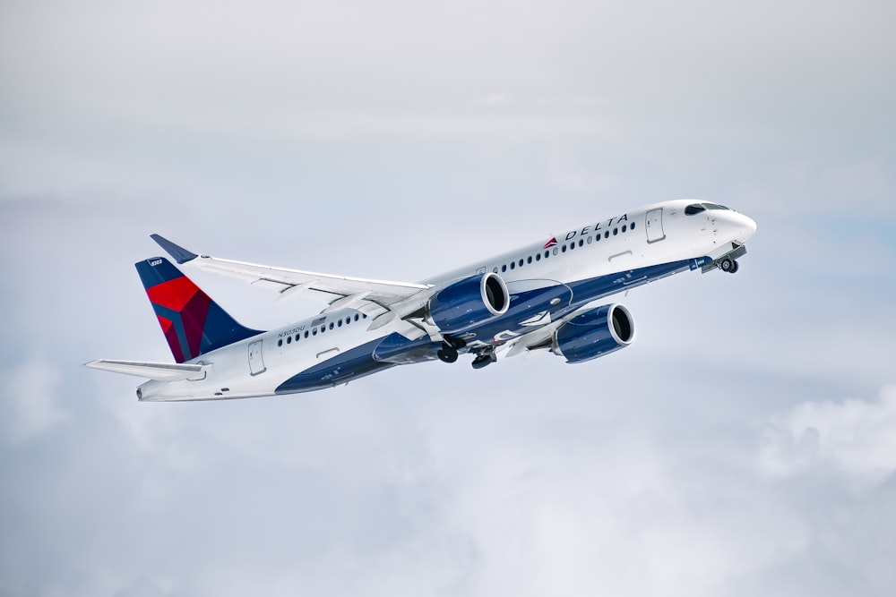 a large passenger jet flying through a cloudy sky