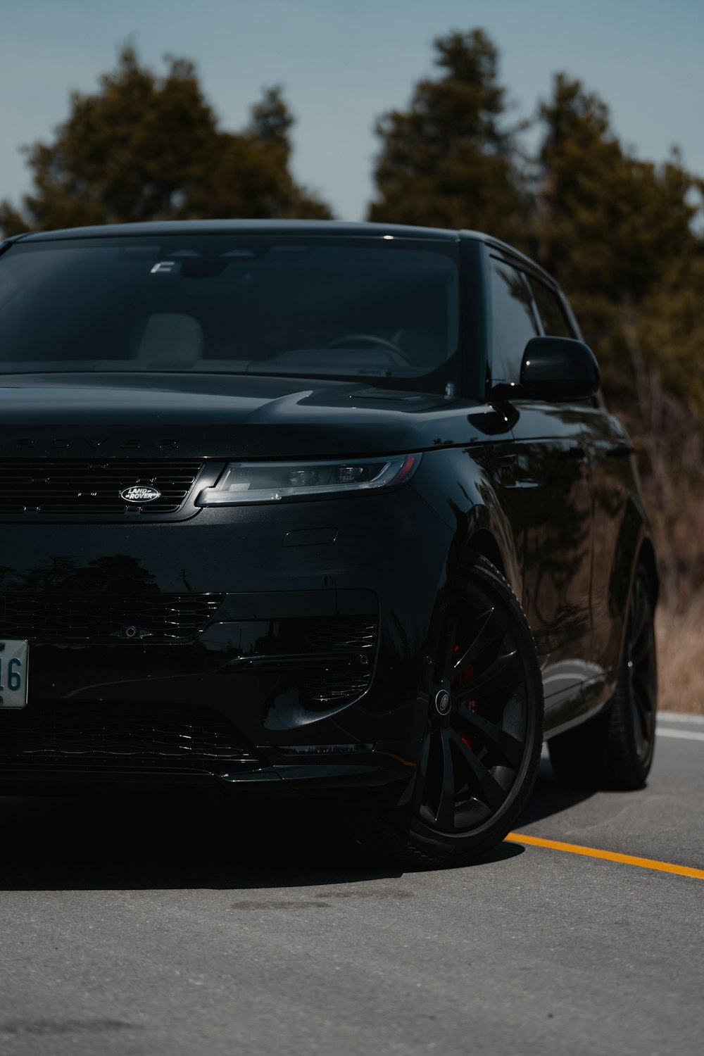 a black range rover parked on the side of the road