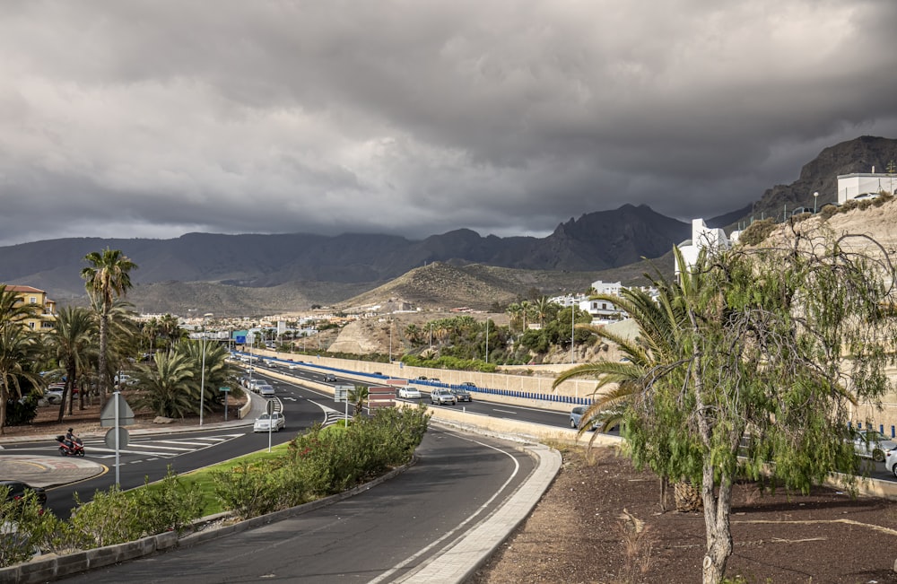 a view of a highway with mountains in the background