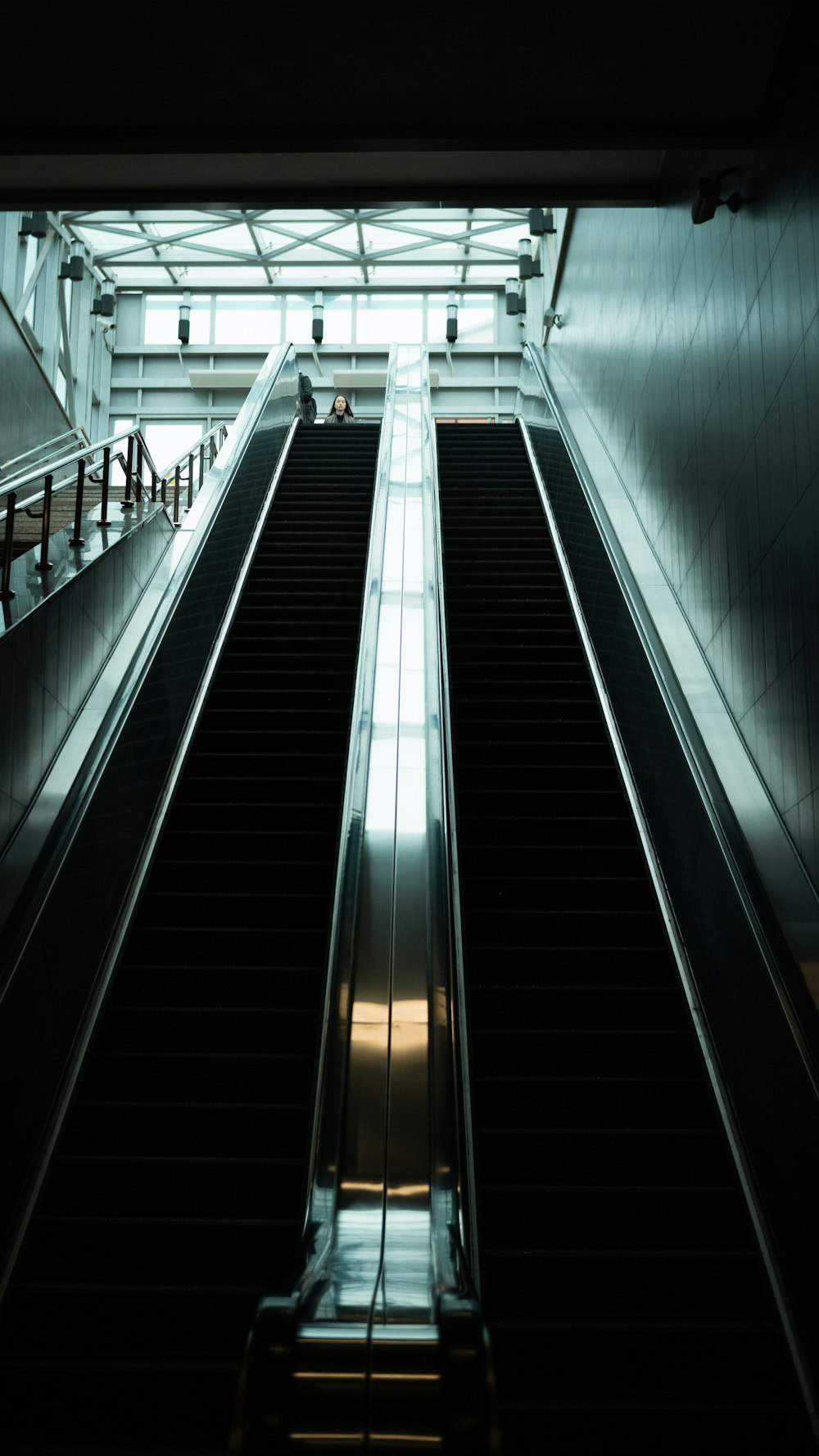 an escalator in a building with people on it
