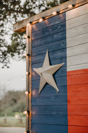 a wooden building with a texas flag painted on it