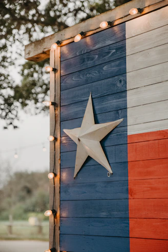 a wooden building with a texas flag painted on it