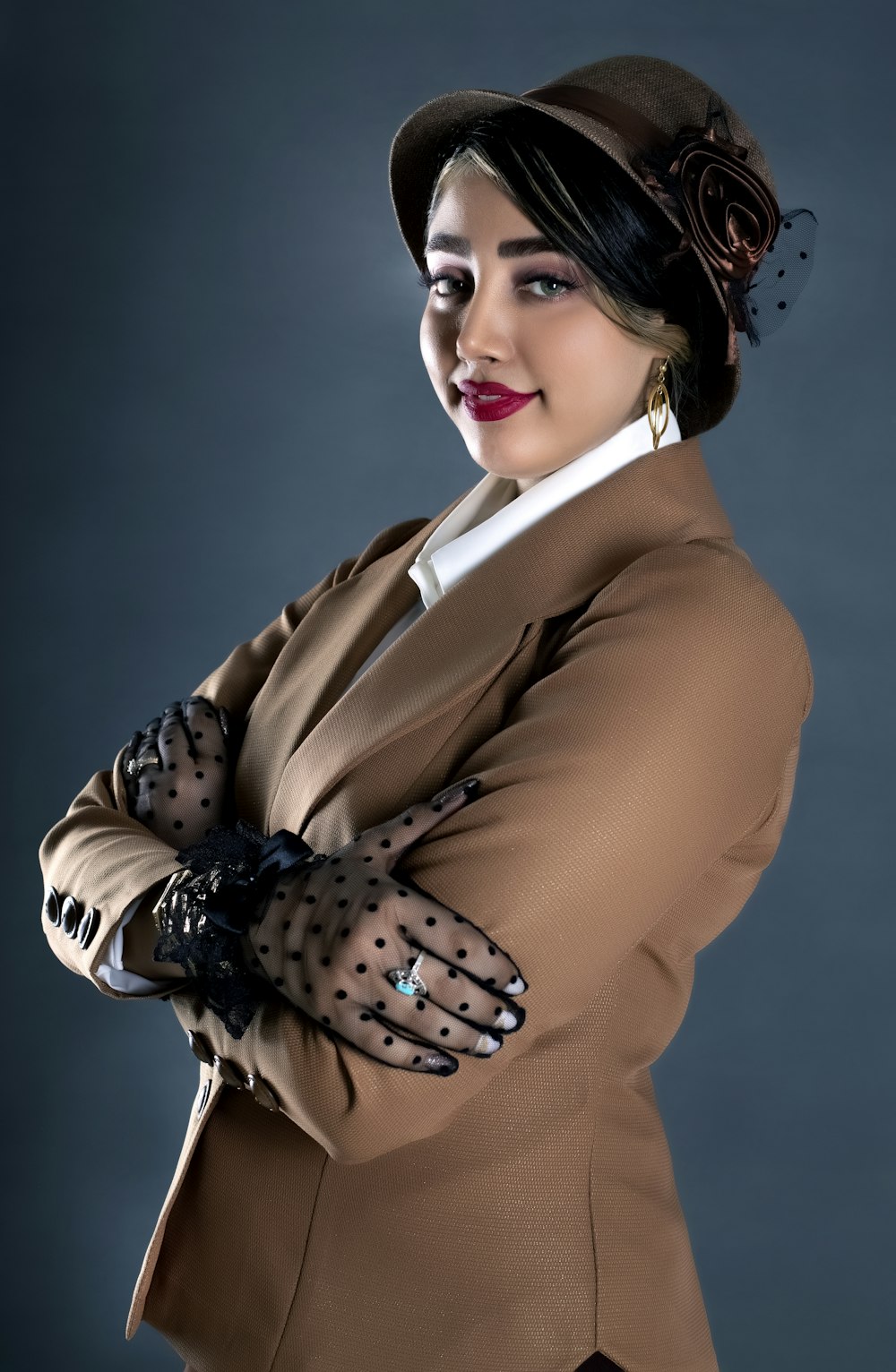 a woman wearing a hat and gloves posing for a picture