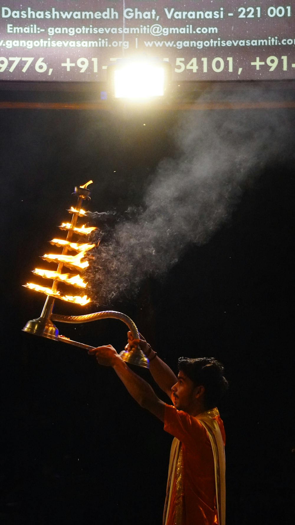 a man holding a lit candle in his hand