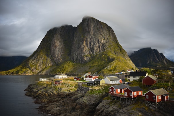 a small village on a small island with a mountain in the background