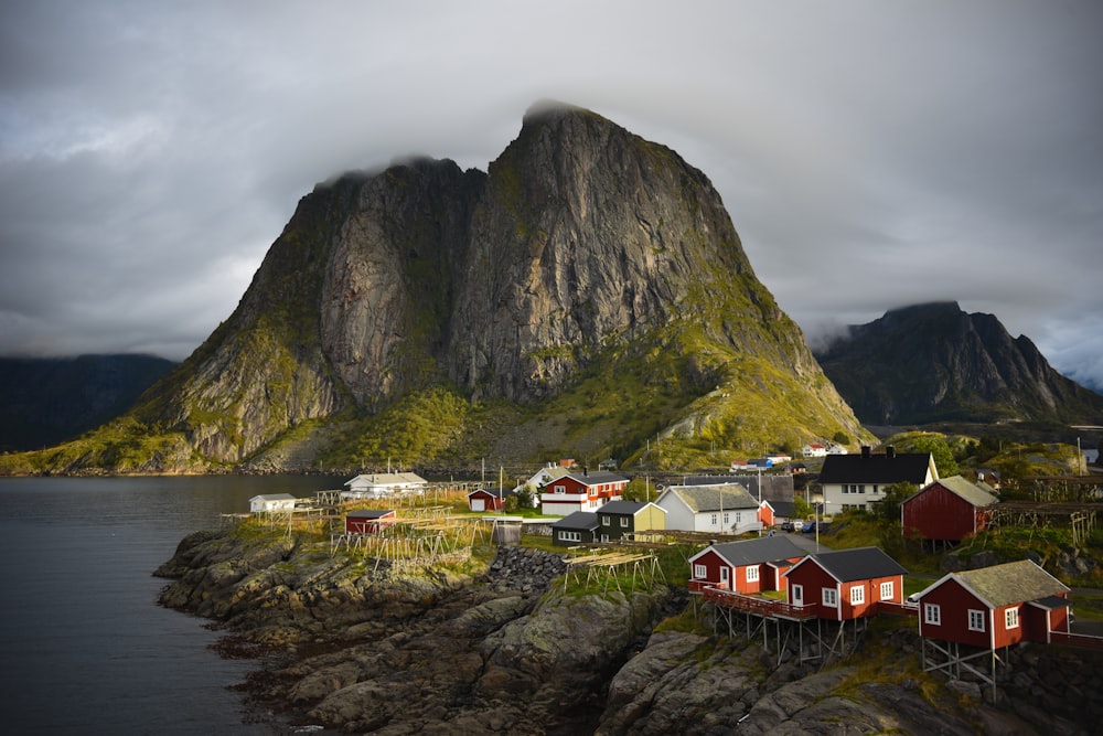 a small village on a small island with a mountain in the background