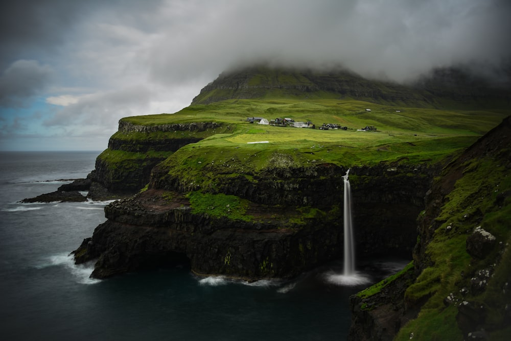 a waterfall in the middle of a body of water