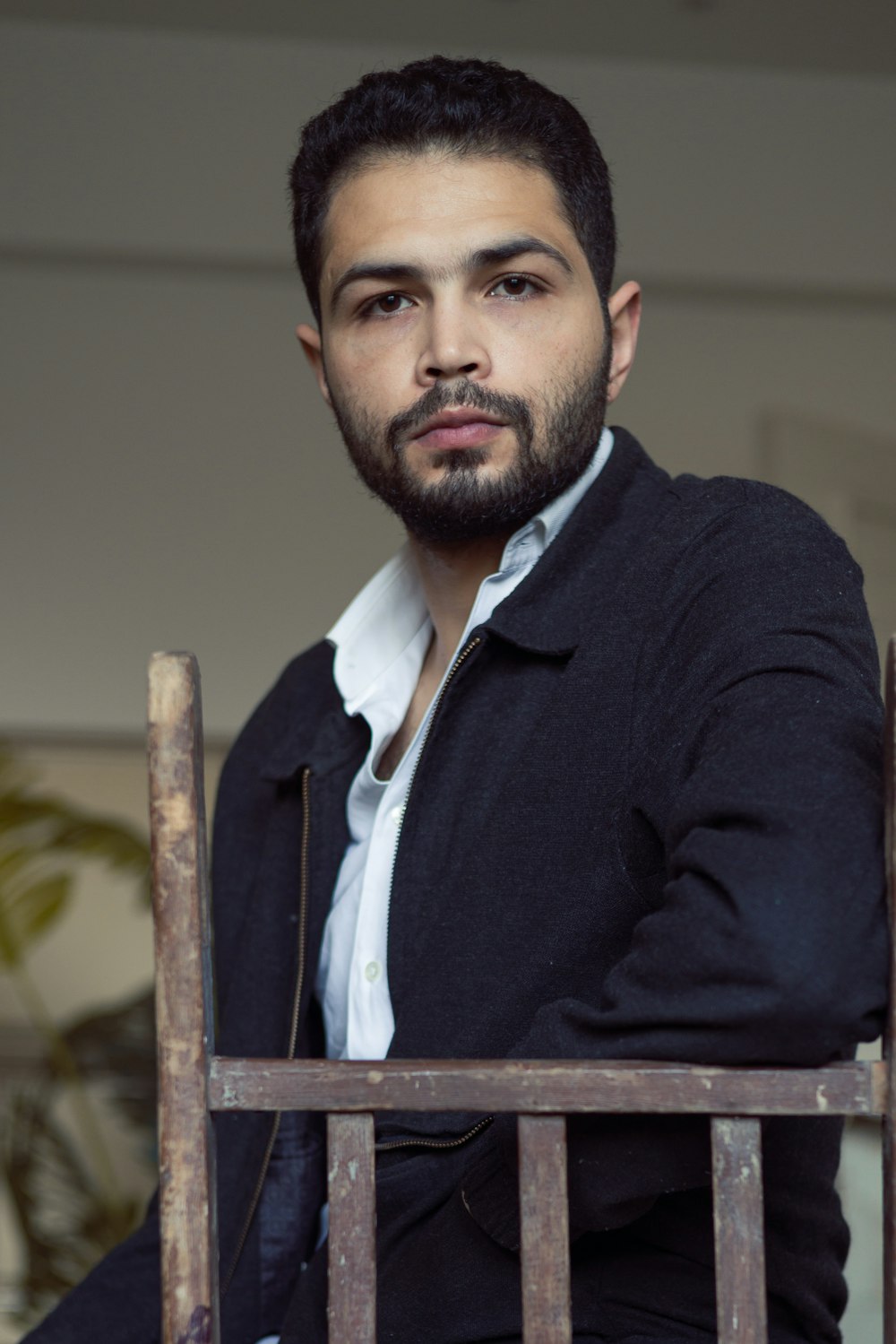 a man with a beard sitting in a chair